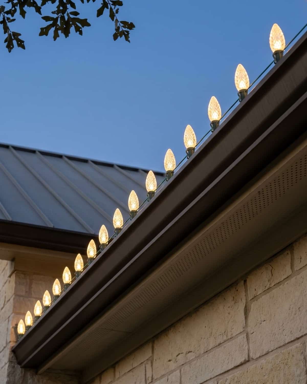 Design mockup: rooflines with warm white Christmas lights at dusk
