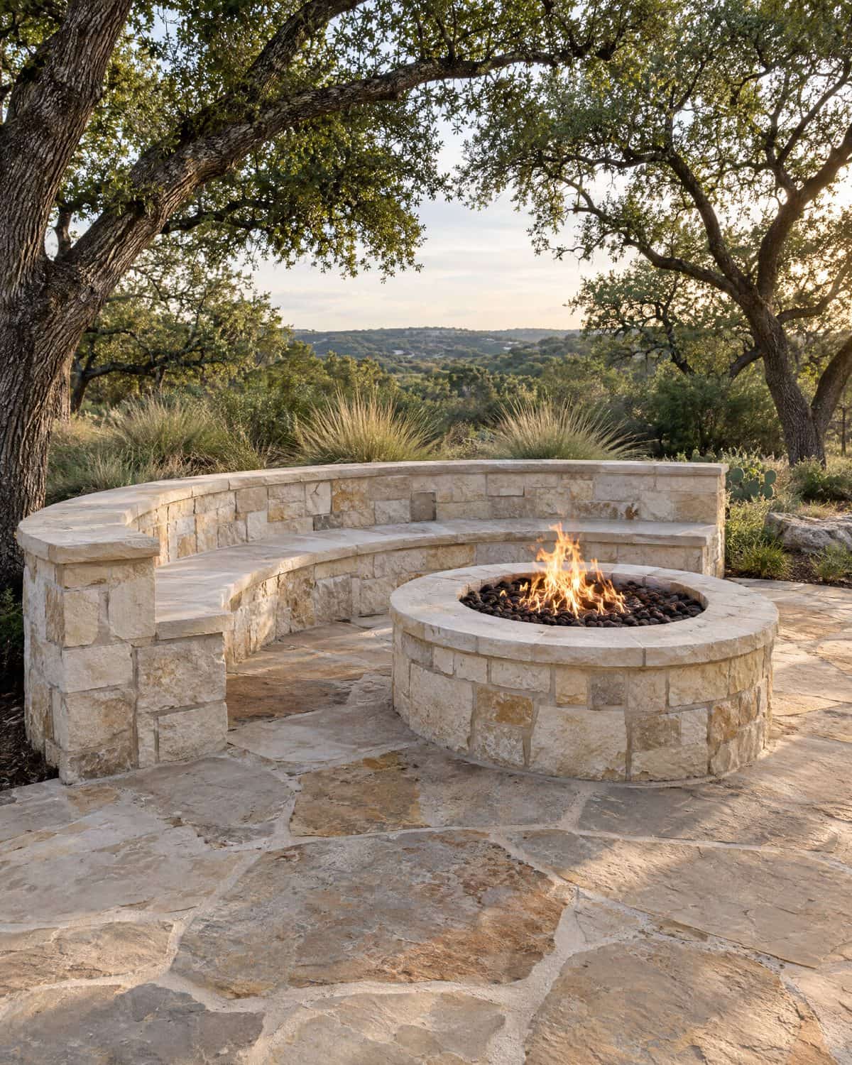 Hand-laid flagstone patio around a limestone fire pit and seat wall