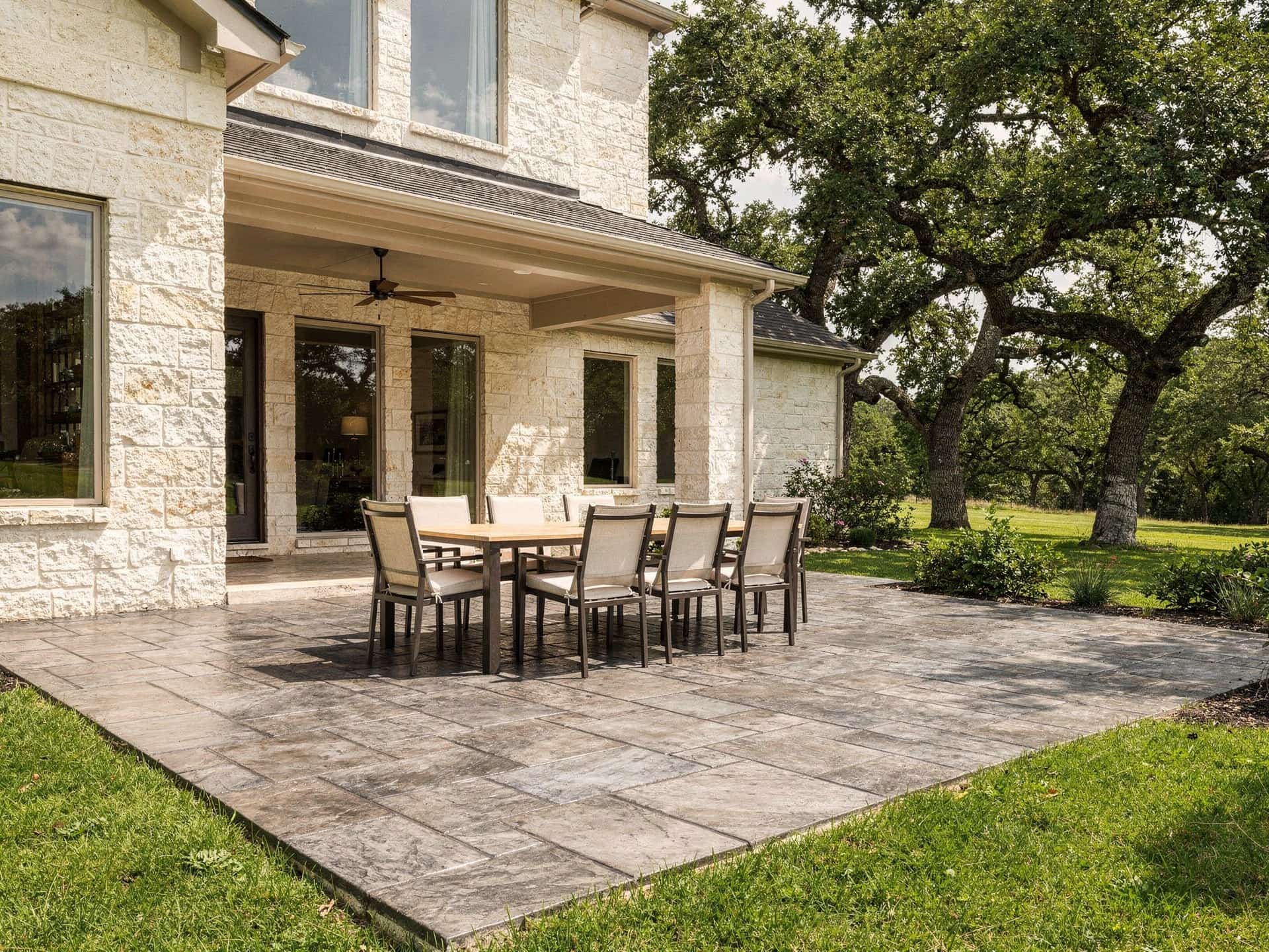 Sealed stamped concrete patio in a slate pattern with a dining table
