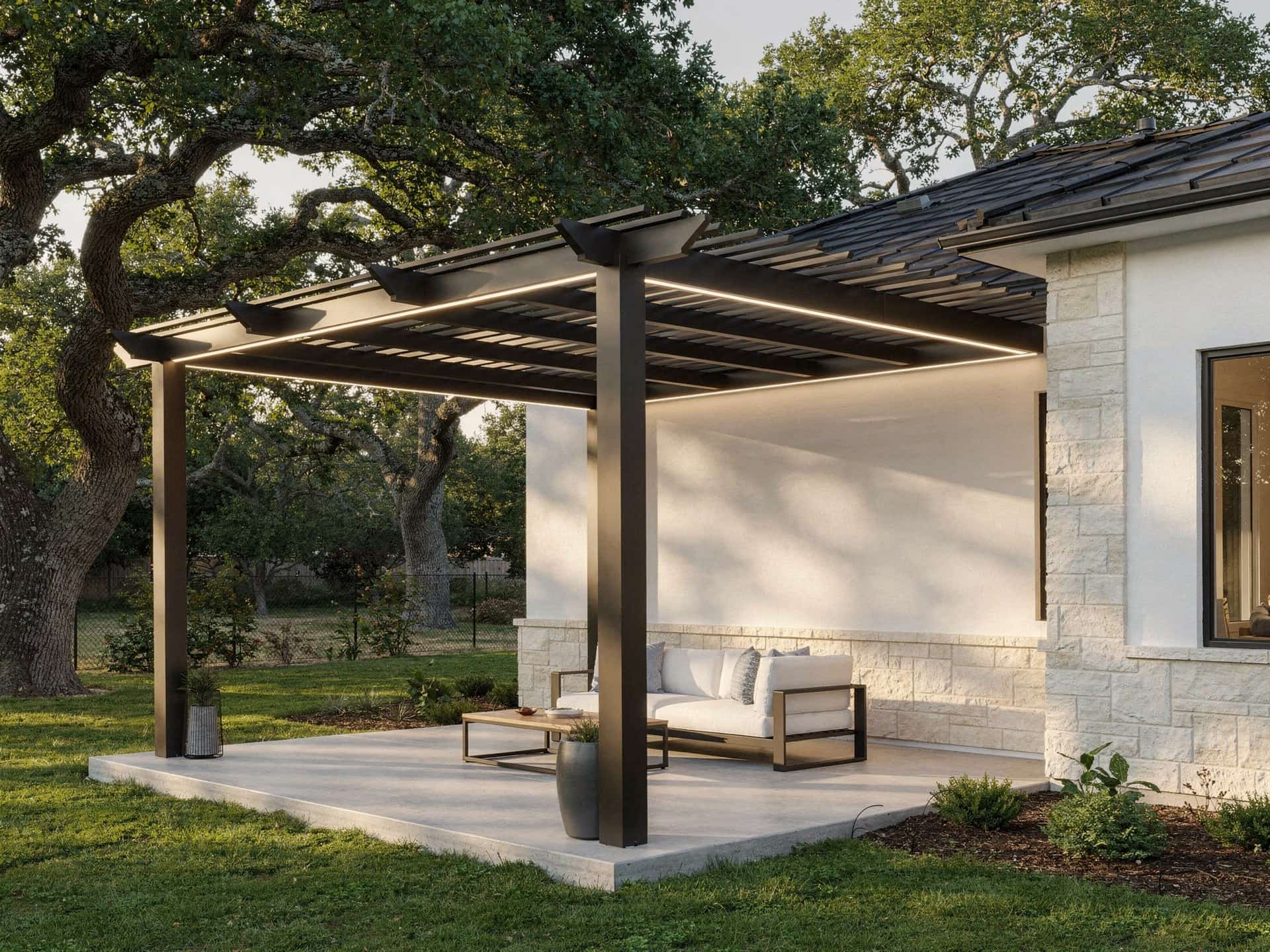 Bronze aluminum pergola with motorized louvers partly open over a patio sofa