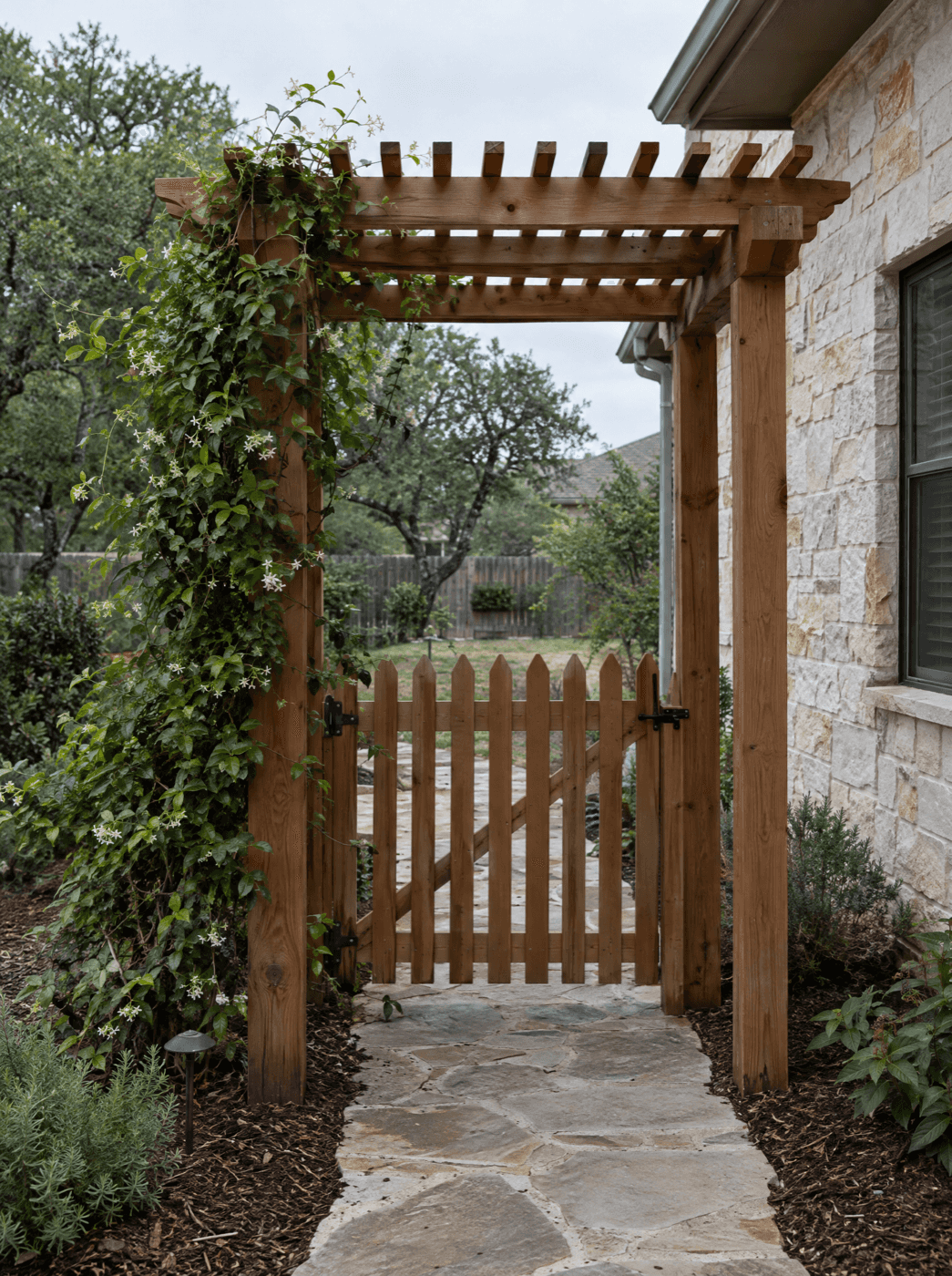 Cedar garden arbor with a wood gate over a flagstone path