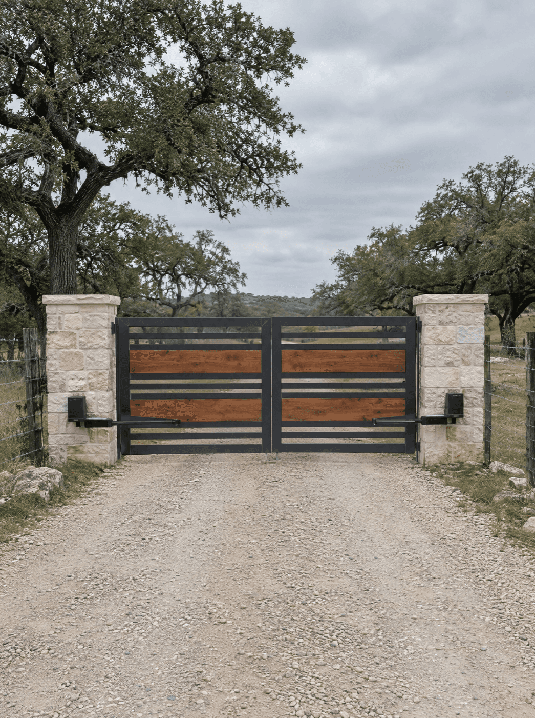 Custom steel driveway gate at a San Antonio Hill Country home by Klema Builders