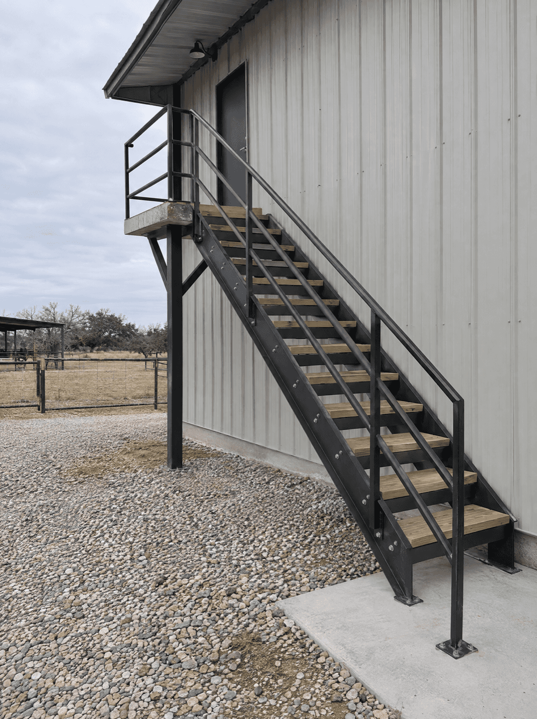 Exterior steel stair with handrails on a metal building
