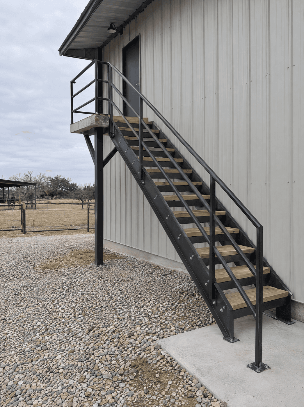 Custom steel stairs and metal handrail at a San Antonio Hill Country home by Klema Builders