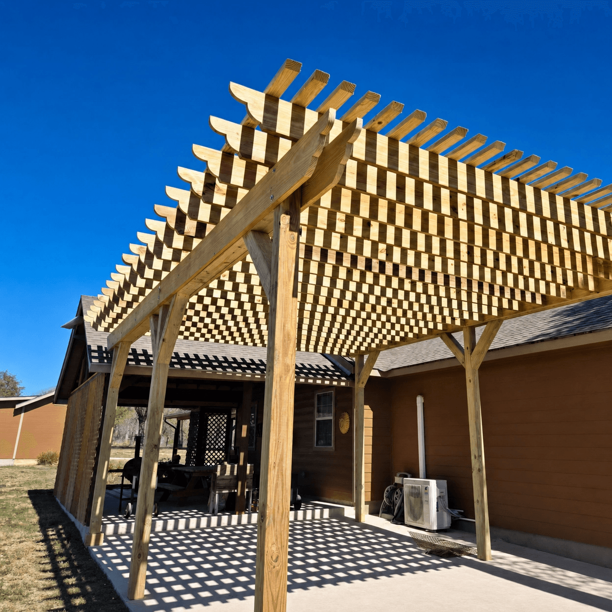 Hand-built cedar pergola over a flagstone patio