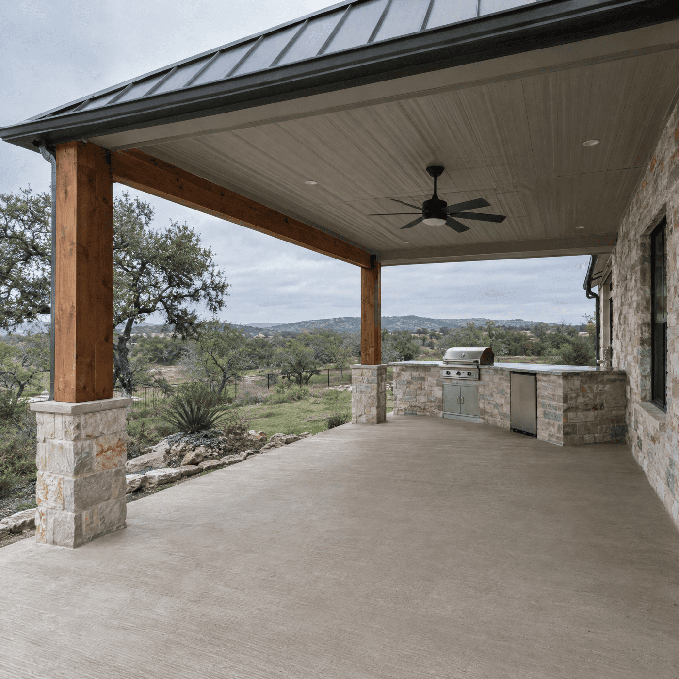 Metal patio cover with an outdoor kitchen and a Hill Country view